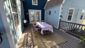a deck with a table and chairs on a house at Hill Country Highland's Bluebonnet Cottage in Marble Falls +48 photos