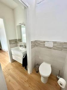 a bathroom with a toilet and a sink at La Casina Verde - Appartamento Mansardato in Livorno