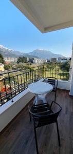 a white table and chairs on a balcony with a view at Apartment Verde in Bar