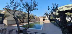 a swimming pool with trees in front of a house at Apartment Verde in Bar