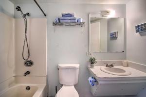 a bathroom with a toilet and a sink and a mirror at Pet-Friendly Vacation Rental Near Boyd Lake in Loveland
