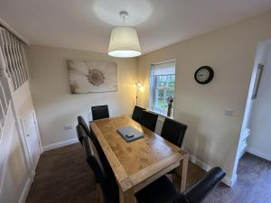a dining room with a wooden table and chairs at Coral Shores - Part of the The Bay Filey Holiday Village with pool, gym and direct beach access, pub, restaurant, tennis and meadows walks in Filey
