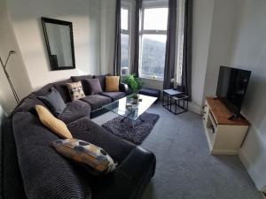 a living room with a couch and a tv at Hill View in Abertillery