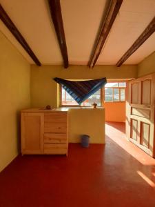 a room with a wooden cabinet and a window at Wayqi Wasi in Pisac
