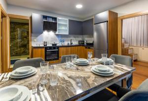 a kitchen with a table with plates and glasses on it at BayMari Suites Plus Florya in Istanbul