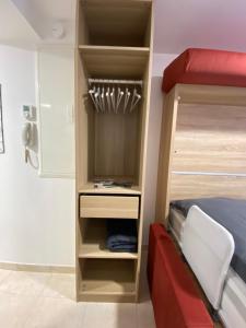 a closet in a room with a bed at Studio Centre Ville in Cambo-les-Bains