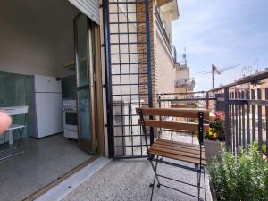 a bench sitting on the balcony of a building at Eufonia Gemelli Apartment in Rome