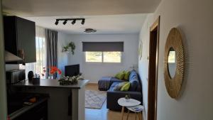 a living room with a blue couch and a table at Apartment in Mar Menor Golf Resort in Torre-Pacheco