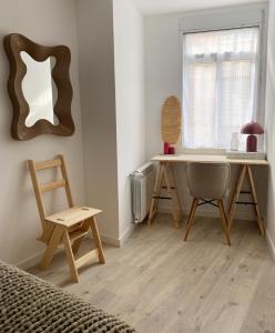 a bedroom with a desk and a chair and a window at Apartamento C/ Concepción Arenal in Ferrol