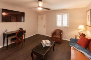 a living room with a couch and a desk at French Quarter Courtyard Hotel and Suites in New Orleans