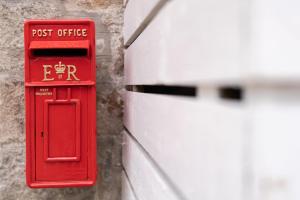 a red post office box on the side of a building at Ranch House Cottage 