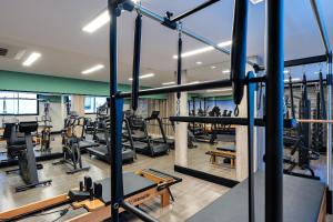 a gym with treadmills and equipment in a building at Xtay Princess Curitiba in Curitiba