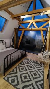 a bedroom with a bed and a large window at Fruska in Sremski Karlovci