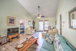a living room with a couch and a table at Oak Island Home with Yard Less Than 1 Mi to the Beach! in Oak Island