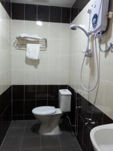 a bathroom with a toilet and a shower at Alor Villa in Malacca