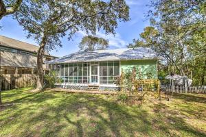 an exterior view of a house with a yard at Oak Island Home with Yard Less Than 1 Mi to the Beach! in Oak Island