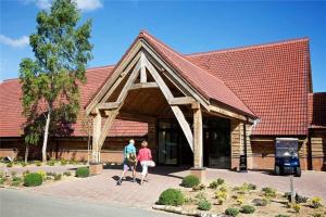 two people walking in front of a building at Lakeview Lodge in Wisbech