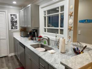 a kitchen counter with a sink and a window at Secluded 3 bed 2 bath condo in Athens close to Five-Points in Athens