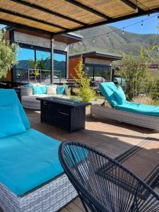 a patio with a couch and chairs on a deck at TEMEXKAL RESORT in Ensenada