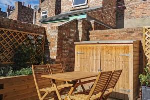 a wooden table and chairs on a patio at 3 Bedroom Townhouse, Free Parking in York
