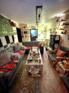 a living room with couches and a coffee table at Petra Heritage House in Wadi Musa