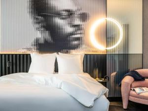 a bedroom with a bed with a picture of a man at Tribe Amsterdam City in Amsterdam