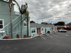 a parking lot in front of a building at The Palomar Inn in Pismo Beach