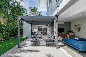 eine Terrasse mit Sofas und Stühlen in einem Haus in der Unterkunft Sunrise SEA-esta in Sunrise Beach