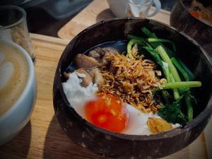 a bowl of food on a wooden table at The Baobab Resort in Sam Roi Yot