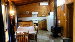 a kitchen with a table and a white refrigerator at Tarra Valley Retreat in Tarra Valley +41 photos