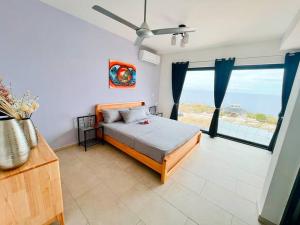 a bedroom with a bed with a view of the ocean at NEU!!! Apartment im Luxory Resort Coral Estate in Willibrordus