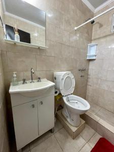 a bathroom with a toilet and a sink at Beva's home Chajari in Chajarí