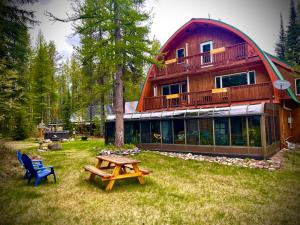 a house with a picnic table in front of it at Moss Mountain Inn in Columbia Falls