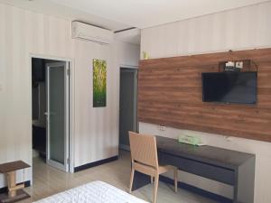 ジンバランにあるNEW KUBU DI BUKITのデスク、壁掛けテレビが備わる客室です。