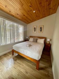 a bedroom with a bed with a wooden ceiling at BIG4 Port Willunga Tourist Park in Aldinga