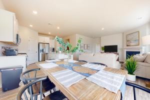 a kitchen and living room with a wooden table and chairs at Millville By The Sea --- 36639 Calm Water Dr in Millville