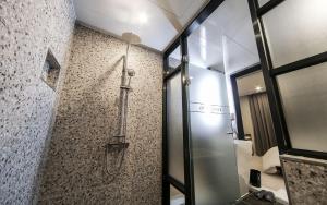 a bathroom with a shower with a glass door at Maron Hotel Nampo in Busan