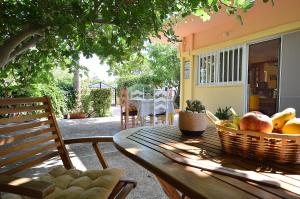 a table with a basket of fruit on a patio at Lush Holiday Home in Kathiana