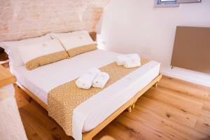 a bedroom with a bed with two towels on it at Montegrappa Dimore e Suite Alberobello in Alberobello +5 photos