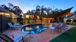 a patio with chairs and a swimming pool at Bridges on Meninya Motel & Apartments in Moama