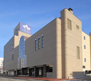 a large brick building on a city street at Hotel Hakodate Royal Seaside BBH Hotel Group in Hakodate