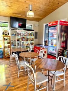 un restaurante con mesas y sillas y una máquina de refrescos en BIG4 Port Willunga Tourist Park, en Aldinga