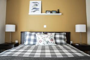 a bedroom with a bed with two lamps and two pillows at The Parthenon Terrace ReNoVaTeD with a view ! in Athens