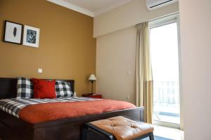a bedroom with a bed and a large window at The Parthenon Terrace ReNoVaTeD with a view ! in Athens