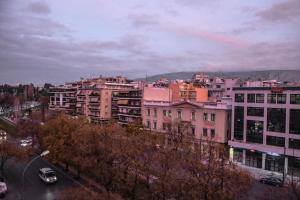 a group of buildings in a city with a street at The Parthenon Terrace ReNoVaTeD with a view ! in Athens
