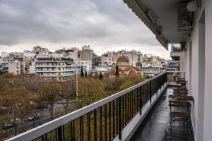 a balcony with chairs and a view of a city at The Parthenon Terrace ReNoVaTeD with a view ! in Athens