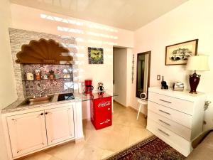 a kitchen with a sink and a red refrigerator at Small pet friendly, Pool and Gym Apartment in San Miguel de Allende