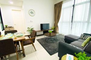 a living room with a couch and a table at The Icon 3 Condo in IOI City Mall Putrajaya, Pool View in Putrajaya