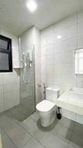 a bathroom with a shower and a toilet and a sink at The Icon 3 Condo in IOI City Mall Putrajaya, Pool View in Putrajaya