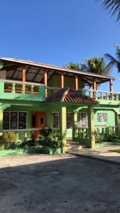 a large green building with a roof at Villa La Esperanza 